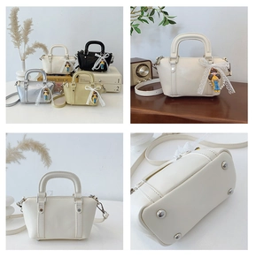 Detail view of four-color Boston bags featuring lace bow charms and bottom metal rivets