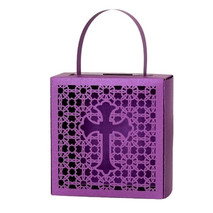 Detail of laser-cut cross pattern on purple metallic candy gift box with handle