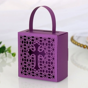 Detail of purple laser-cut candy box featuring hollow flower patterns and a cross