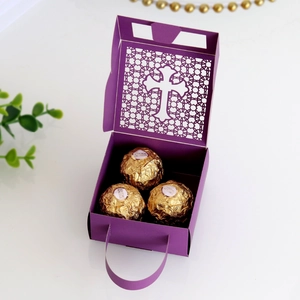 Macro shot of purple laser-cut cross favor box with delicate geometric patterns