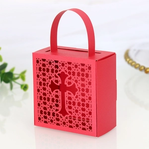 Macro detail of red paper gift box featuring laser-cut cross design and lace texture