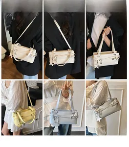 Detail of elegant shoulder bag with star pendant and bow accent in multiple soft colors