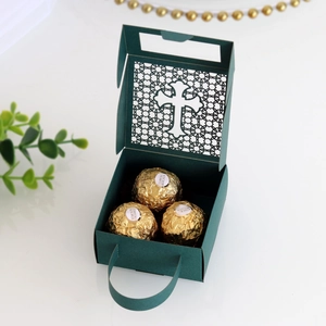 Detail of dark green hollow cross candy box with laser cut design and gold handle