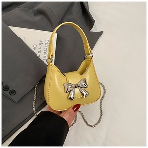 Détail du nœud en métal argenté sur le mini sac hobo jaune vif avec chaîne