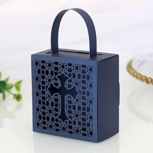 Detail of laser-cut cross pattern on navy blue pearlescent paper wedding favor gift box