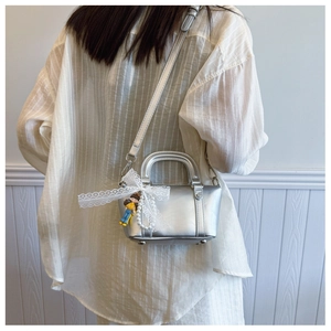 Silver faux leather saddle bag with lace bow, pearl chain and cute cartoon charm