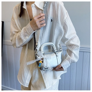 Silver metallic doctor bag with lace bow, cute doll pendant and pearl chain detail