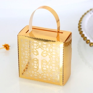 Close-up of golden cross hollow gift box with metallic mirror finish and handle
