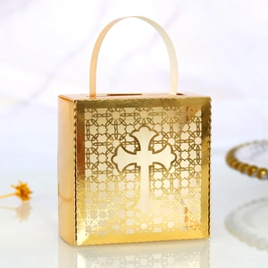 Macro shot of golden hollow cross gift box with laser-cut patterns and curved handle