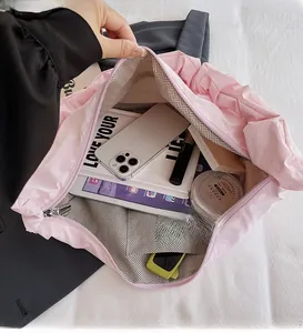 Pink nylon tote interior view showing spacious capacity with tablet, phone and books