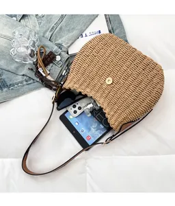 Overhead view showing large capacity of woven straw bucket bag with magnetic closure
