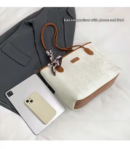 Size comparison of snakeskin tote bag with iPad and phone to show large capacity