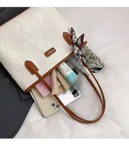 Spacious tote bag with snake texture showing inner storage for phone and makeup