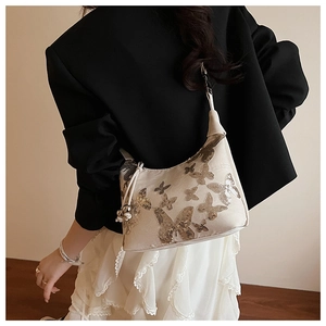 Detailed view of sequined butterfly pattern on beige crossbody underarm bag for women
