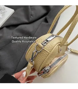 Detail of premium silver hardware and lychee pattern leather on beige crossbody bag