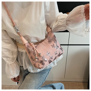 Detailed view of pink sequin butterfly embroidery and drawstring on small crossbody bag
