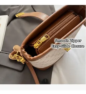 Close-up of smooth golden zipper and premium leather trim on monogram bucket bag
