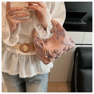 Detail of pink sequin butterfly embroidery and metallic beads on vintage shoulder bag