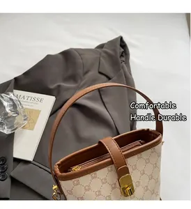 Detail of vintage monogram bucket bag with brown leather trim and gold buckle closure