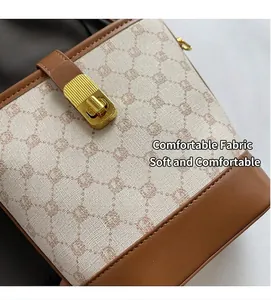 Detail of contrast bucket bag with vintage monogram fabric and gold metal twist lock