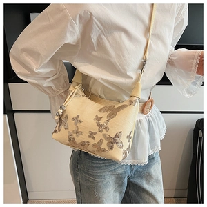 Detail of beige sequin butterfly embroidery on stylish crossbody shoulder bag