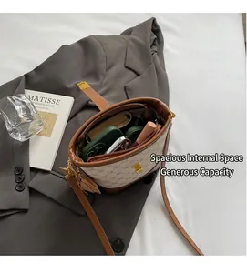 Detail view showing large capacity for phone and lipstick in beige monogram bucket bag