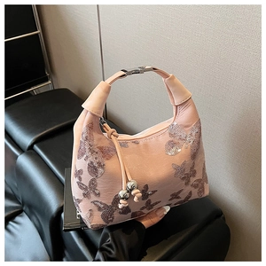 Pink lychee leather hobo bag with sequined butterfly embroidery and tassel charm