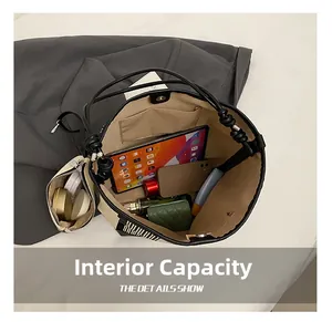 Interior view showing the large capacity and removable pouch of this bicolor tote bag