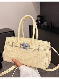 Chic beige woven Kelly style handbag with silver hardware and adjustable shoulder strap