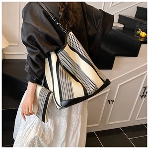 Detailed view of the black and white striped canvas tote bag with matching pouch for daily use