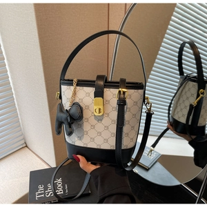 Détails du sac seau contrasté avec motif géométrique et breloque en forme de cheval