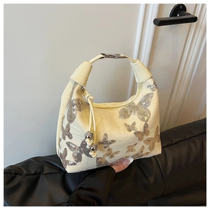Detail of cream shoulder bag with silver sequin butterfly embroidery and metal bead charm