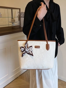 Large snake print tote bag in cream white with brown handles and a dotted scarf detail