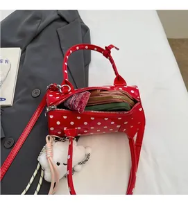 Detailed interior of red polka dot barrel bag showing spacious storage and lining