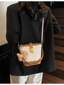 Sac seau bicolore chic avec imprimé lettres et garniture en cuir porté par un mannequin