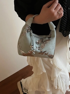 Elegant mint green hobo bag with sequined butterfly embroidery and silver metal charms