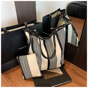 Detailed view of the black and white striped tote bag with matching zippered pouch