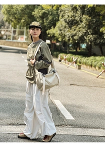 Outdoor-Straßenstil-Ansicht einer übergroßen, cremeweißen Nylon-Umhängetasche