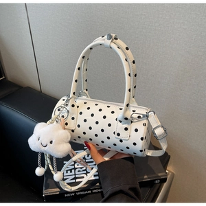 Close-up of white cylinder handbag with black polka dots and cute cloud charm