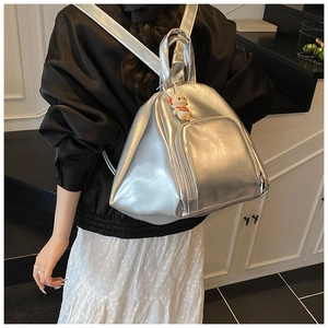 Silver metallic backpack with front zip pocket and cute cat pendant charm on the handle