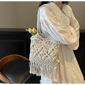 Détail d'un sac en coton crocheté à la main avec motifs ajourés et longues franges