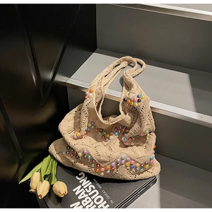 Close-up of beige crochet tote bag featuring vibrant colorful pearls and hollow knit detail