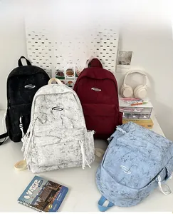 Multi-color school backpack set in black, marble, and blue with front zip pockets