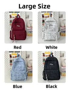Detail view of the large casual backpack in red, white, blue, and black marble patterns