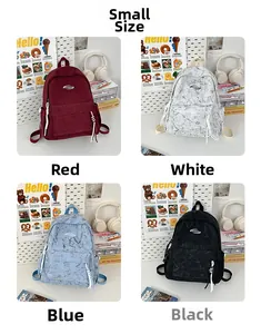 Detail of corduroy backpacks in four colors including red, blue, black, and light grey