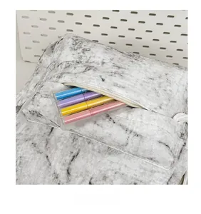 Detailed close-up showing the front zipper pocket and marble pattern of the school backpack