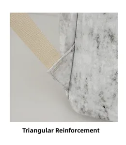 Close-up of triangular bartack reinforcement on durable grey marble texture backpack