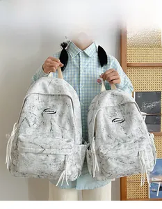 Detailed comparison of large and small marble pattern backpacks shown by model