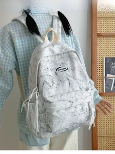 Model wearing a minimalist white backpack with marble patterns and drawstring side pockets