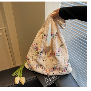 Detailed knit tote bag showing colorful pearl beads and hollow crochet texture